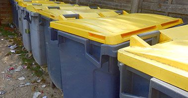 A row of bins with yellow lids