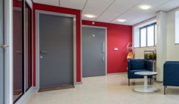 Inside an office with red walls.