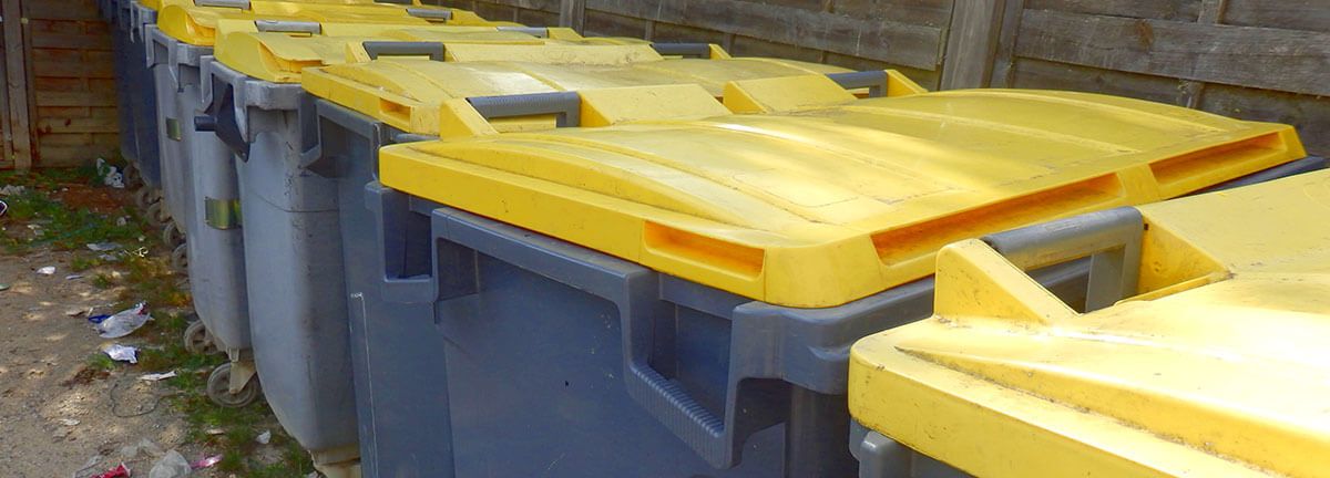 Row of bins with yellow lids
